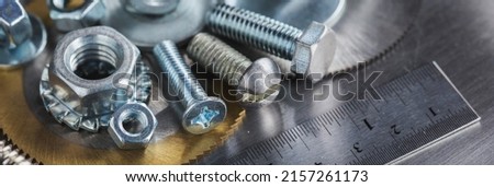 set of different nuts, bolts, screws, washers and drill bits,thread tap and mill cutters on steel plate background. Locksmithing deal.