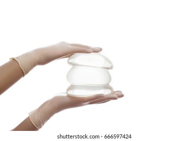 A Set Of Different Silicone Breast Implants On Hands

