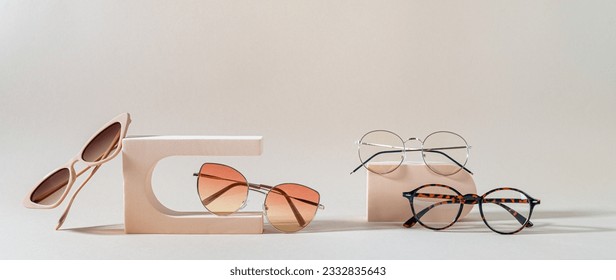 Set of different sunglasses and eyeglasses on podiums on beige background. Summer fashion eyeglasses collection. Sunglasses sale, discount, promotion banner. Minimal style flat lay, copy space
