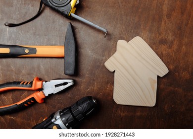 Set of different tools for repair and house on a wooden background