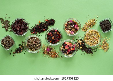 A Set Of Different Types Of Green, Black And Herbal Tea On A Green Background. Delicious Organic Drinks. View From Above. A Place For Text.