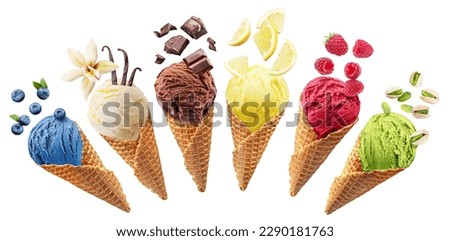 Set of different types of ice cream balls in waffle cones with ice cream ingredients - fruits, berries and sweets. Isolated on a white background. Clipping Path.