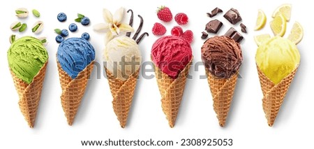 Set of different types of ice cream balls in waffle cones with ice cream ingredients - fruits, berries and sweets. Isolated on a white background.