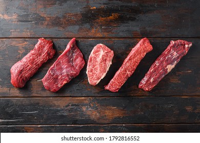 A set of different types of raw beef steaks alternative cut flap flank Steak, machete steak or skirt cut, Top blade or flat iron beef and tri tip, triangle roast with denver cut top view space for