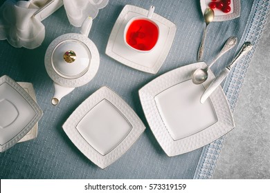 Set Of Dinnerware On Grey Tablecloth