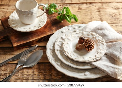 Set Of Dinnerware On Wooden Table