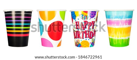 A set of disposable, paper party cups for birthdays and other celebrations and parties.  Isolated on a white background.
