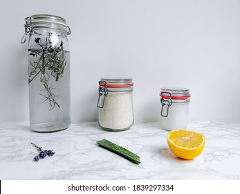 Set Of DIY Cleaning Products Such As Fabric Softener And Laundry Detergent With Natural Ingredients Such As Lavender, Aloe Vera And Lemon