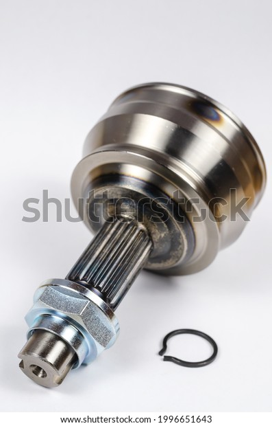 Set Drive shaft joint on white background. New\
Constant velocity joints, hub nut and retaining ring. The constant\
velocity joint provides torque transmission on front-wheel drive\
vehicles. Parts