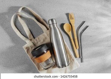 Set of Eco friendly bamboo cutlery, eco bag and reusable coffee mug. Sustainable lifestyle. Plastic free concept.