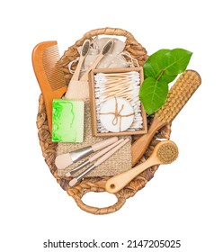 Set Of Eco Natural Bathroom Accessories In Natural Basket Isolated On White Background, Top View. Zero Waste Cosmetics Products Sustainable Body Care Products With Green Leaves.