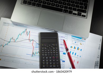 Set Of Economic Scenario, Accounting Desk. Computer With Economic Blurred Reports And Red Pen For Work