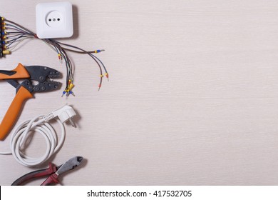 Set of electrical tool on wooden background. Accessories for engineering work, energy concept
