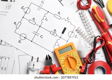 Set of electrician's tools and accessories on paper sheets with scheme, flat lay