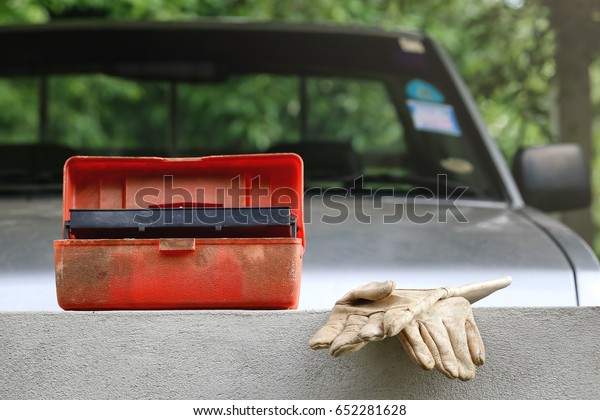 a set of emergency kit in car with glove ,\
car on background.