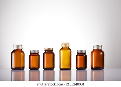Set of empty brown glass medicine bottles. Amber bottle samples. 