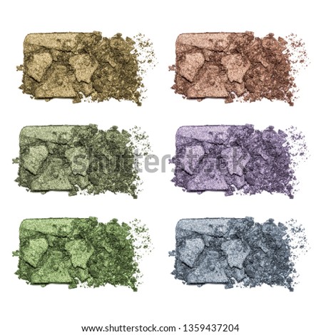 Set of eyeshadow sample isolated on white background. Crushed brown, blue, green metallic eyeshadow. Closeup of a makeup product.