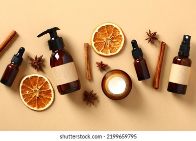 Set of fall natural skincare cosmetics with dried orange slices, cinnamon sticks, anise stars. Amber glass bottes packaging design. - Powered by Shutterstock