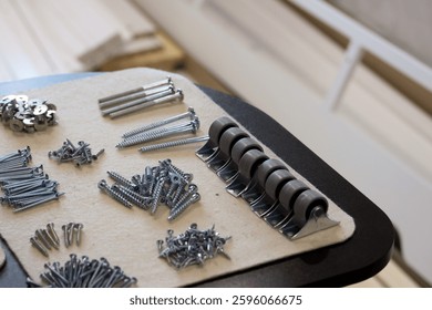 Set of fasteners for assembling an ottoman. Laid out for convenience. Close-up view.