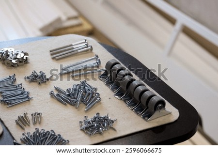 Set of fasteners for assembling an ottoman. Laid out for convenience. Close-up view.