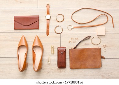 Set of female accessories on light wooden background - Shutterstock ID 1991888156