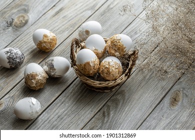 Set of festive Easter eggs in a wicker basket on a blurred background. Easter holiday concept.