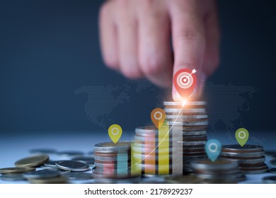 Set Financial Goals Concept. Businessman Is Tapping On Top Of Coins, Setting Business And Financial Goals, Saving Money, Investing Money, Growing Business Graph, Increasing Profit On Investment.