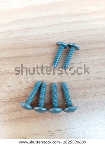 Set of five 4x16mm pan-head tapping screws, genuine specification fasteners designed specifically for Honda motorcycles. Features wide rounded head, standard thread, and durable finish. Arranged in ascending length order on smooth light wood surface. Widely used in motorcycle body, fairing, and component installation.