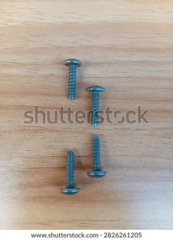 Set of five 4x16mm pan-head tapping screws, genuine specification fasteners designed specifically for Honda motorcycles. Features wide rounded head, standard thread, and durable finish. Arranged in ascending length order on smooth light wood surface. Widely used in motorcycle body, fairing, and component installation.
