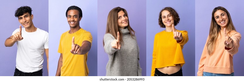 Set Of Five Person Over Isolated Purple Background Showing And Lifting A Finger