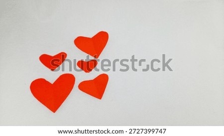  A set of five red paper hearts on white. Ideal for minimalist graphic design, DIY craft blogs, and social media marketing assets for the season of love. High contrast and clean composition