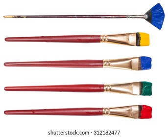 set of flat artistic paintbrushes with painted tips isolated on white background