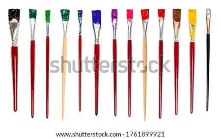 set of flat paint brushes with various colored tips isolated on white background