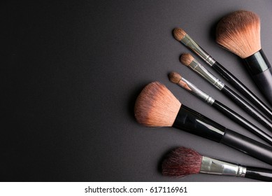 Set of flat top view of various professional female cosmetics brushes for makeup and eyelash brush isolated on black background, Cosmetics concept, Make up concept, Copy space image for your text.