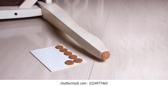 Set floor care pad, chair wooden leg. Adhesive chair and sofa protector. Anti-skid felt pad cover sticking on wooden furniture leg.  - Shutterstock ID 2124977465