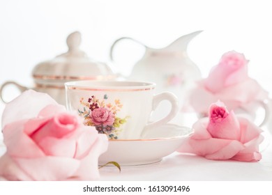 A Set Of  Floral Rose Pattern Fine China Porcelain Tea Set With A Tea-pot, Sugar Pot, Creamer, And Tea Cup.