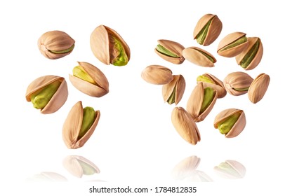 A set with Flying in air fresh raw whole and cracked pistachios  isolated on white background. Concept of Pistachios is torn to pieces close-up. High resolution image - Shutterstock ID 1784812835