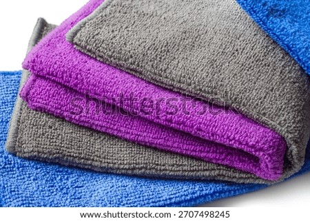 A set of folded microfiber towels close-up. Colorful Microfiber Cloths