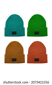 Set of four colorful knitted beanie hats with black unbranded mockup label isolated on white background.