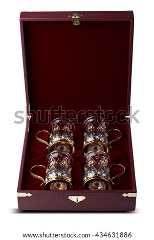 A set of four glasses with silver cup holders in finely crafted maroon, leather gift boxes