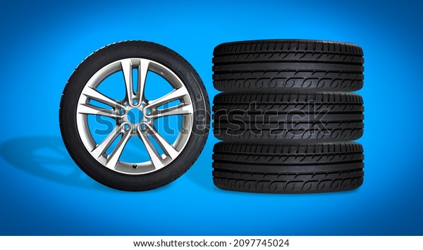 Set of\
four wheels on blue background. New tires on aluminum wheel rims.\
No logo visible, only tire labeling\
visible.