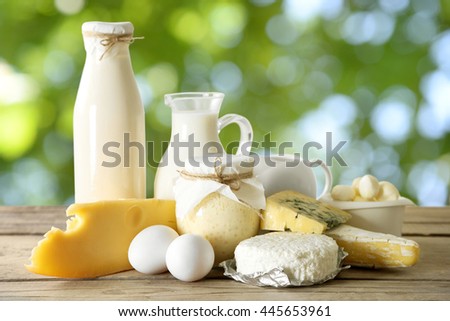Set of fresh dairy products on wooden table on natural background