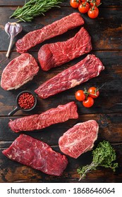 Set of fresh raw alternative beef steaks flap flank Steak, machete steak or skirt cut, Top blade or flat iron beef and tri tip, triangle roast with denver cut top view over old butcher wood table