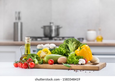 Set of fresh raw vegetables tomato, egg, mushrooms, salad, pepper, squash on a white wood table in a modern kitchen room. Healthy Eating. Organic food. - Powered by Shutterstock