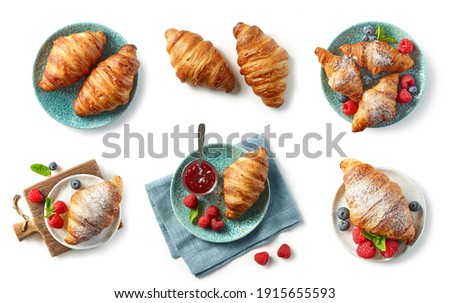 set of freshly baked croissant and jam on blue plate isolated on white background, top view