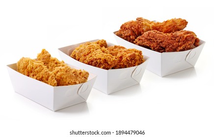 Set of fried breaded chicken in white cardboard boxes isolated on white background