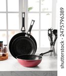 Set of frying or cooking pans. They are nonstick and iron cast. A set of pans from different size. Nonstick cookware is good for home usage only. The coating can be easily removed depend on quality