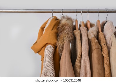 Set Of Fur Jacket ,coat ,sweater, Scarf , Clothes On Hanger –gray Background
