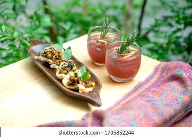 Set Of Fusion Food Of Asian Include : Scalloped Mussels Or Tiny Clams  In Crispy Rice Cake  And Chili Cocktail With Rosemary. Food S Serving On The Garden Background 
