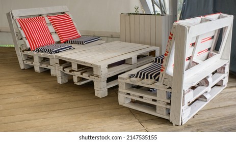 A set of garden furniture made from used pallets in an elegant nautical style. Concept of reuse, upcycling, modern summer beach holiday. - Shutterstock ID 2147535155